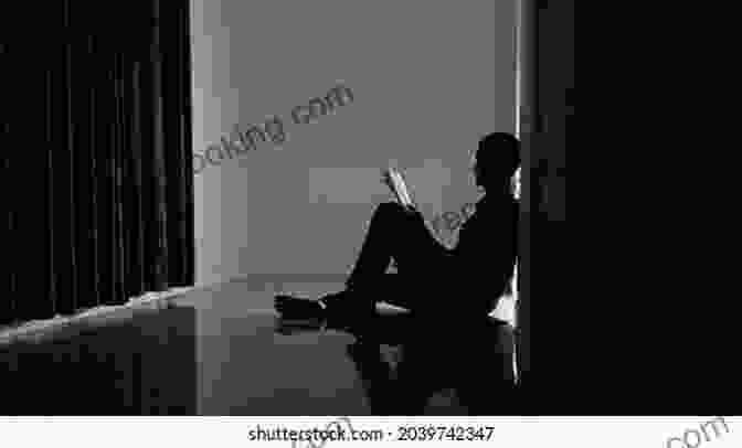 A Person Sitting Alone In A Dark Room, Head In Hands, Looking Distressed. Daughter Of Gloriavale: My Life In A Religious Cult