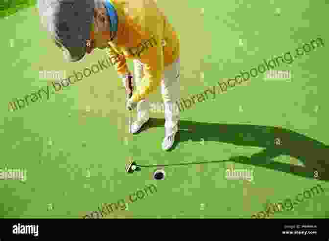 Man Playing Golf With Wooden Stick Concentrating On Putting The Golf Ball Into The Hole Mastering The Mental Side Of Tournament Golf